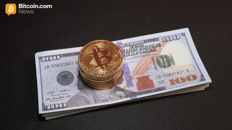 Pile of bitcoin on $100 dollar bill