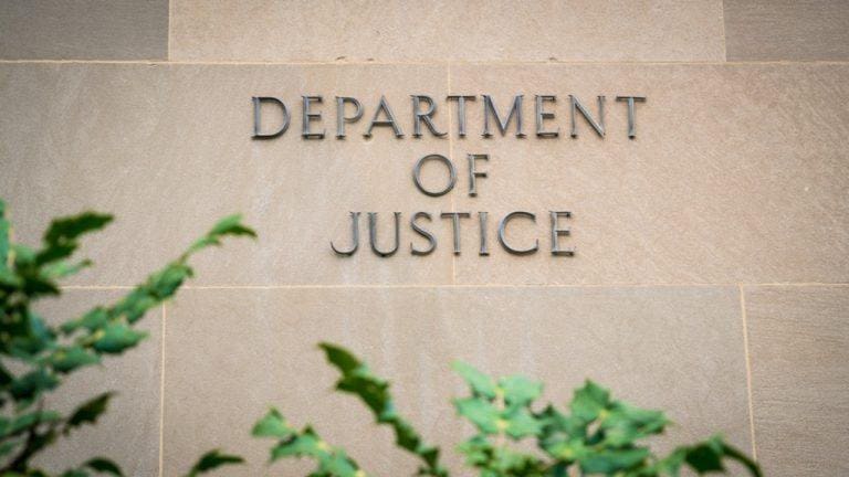 Department of Justice written on a wall