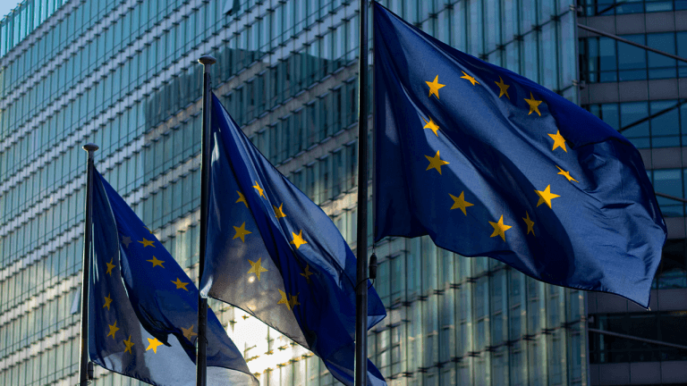 European flags waving in the city on a sunny day.